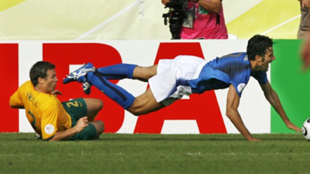 Disaster... Italy's Fabio Grosso goes over the top of Lucas Neill in the penalty box during the last World Cup.