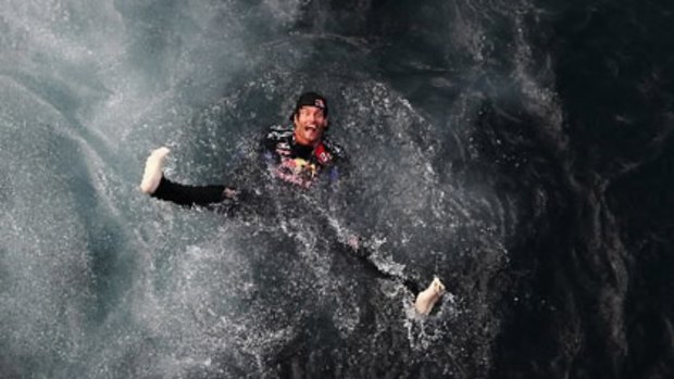 Mark Webber celebrates by jumping into Monaco's harbour.