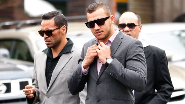 Ferguson arrives at court on indecent assault charges in 2013, flanked by Anthony Mundine.
