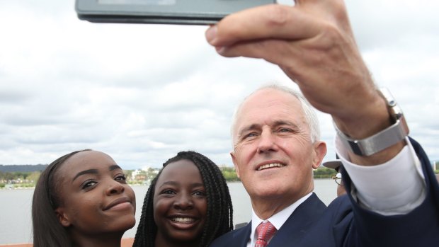 Prime Minister Malcolm Turnbull takes a selfie with new Australian citizens Lydia Banda-Mukuka and Chilandu Kalobi Chilaika after the citizenship ceremony on Australia Day this year.