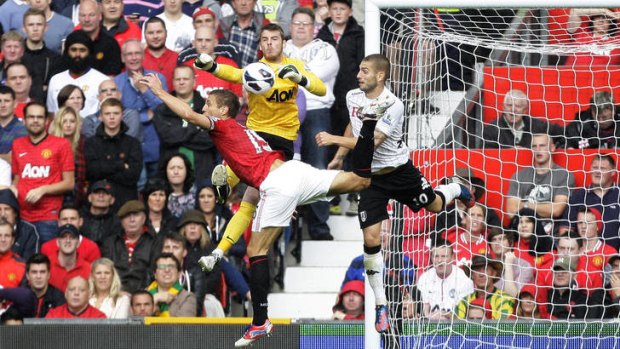 Manchester United's Nemanja Vidic, left, scores an own goal past goalkeeper David De Gea during the match against  Fulham.