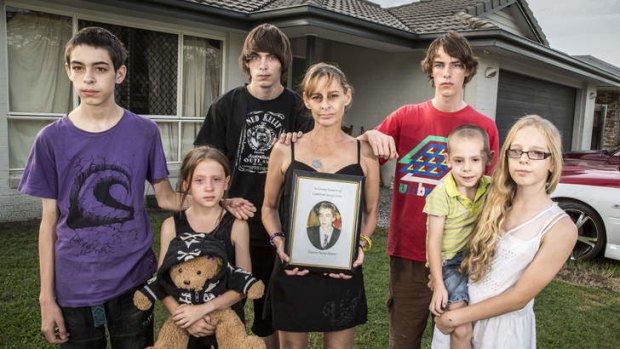Rikki Smith holding a picture of her dead son Cameron Lowe with her children: (left to right) Wyatt Lowe (15), Maddison Sampson (9), Kyle Lowe (18), Zac Lowe(16), Luke Sampson(5) and Briana Bierman(13).