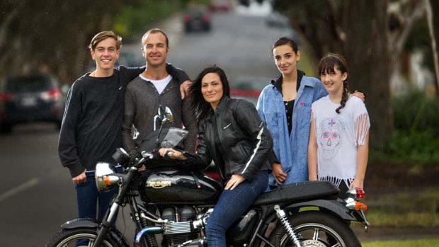 Darrylin Galanos with her motorbike and her family (from left) Isaac, Graeme, Grace and Jemma Gbbons.