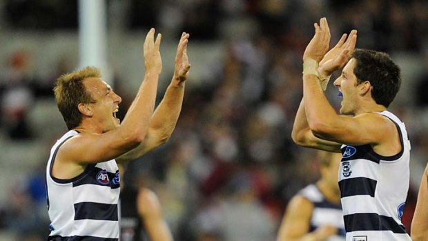 Geelong's Darren Milburn celebrates the Cats win against St Kilda in round one with Harry Taylor.