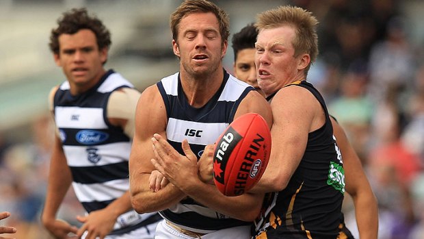 Jack Riewoldt, who kicked four goals for the Tigers, collides with Geelong's Joel Corey.