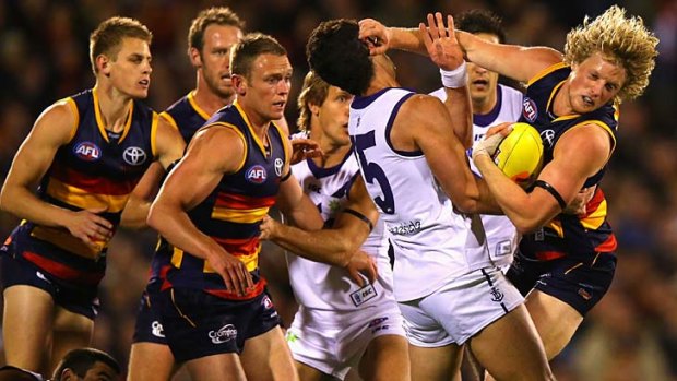 In your face: Ryan Crowley gets up close and personal with Adelaide's Rory Sloane and his teammates during last year's finals.