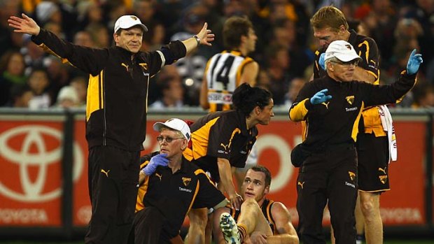 Trainers call for a stretcher for Jarryd Roughead after he ruptured his Achilles tendon.