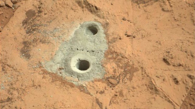 The hole in a rock called "John Klein" where the rover conducted its first sample drilling on Mars.