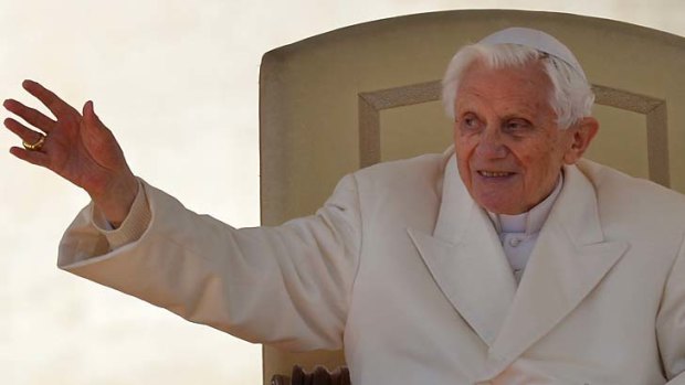 Poignant &#8230; Pope Benedict waves from the altar during his final general audience. He spoke of ''stormy waters'' but said God would not let the Church ''sink''.