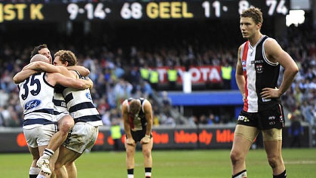 Geelong players celebrate last year's grand final win.