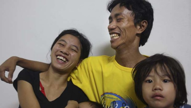 So happy ... Kham Kap Thang Taithoul and family, the first refugees to come to Australia through the Malaysia deal.