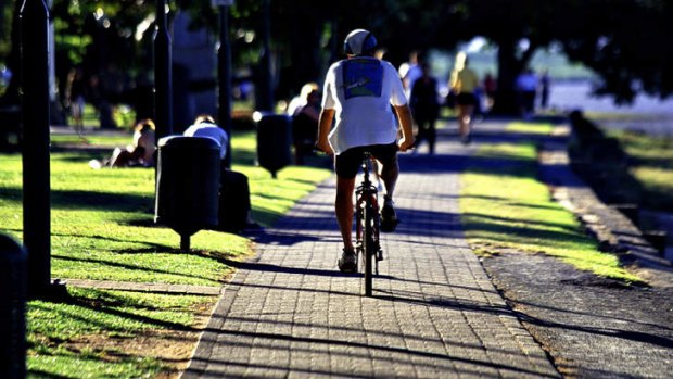 Different strokes: a cyclist in Cairns, where bicycles are allowed on the footpath.