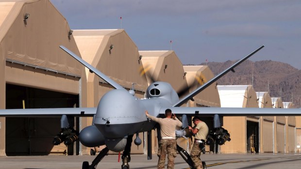 US airmen prepare a US Air Force MQ-9 Reaper drone as it leaves on a mission at Kandahar Air Field, in Afghanistan