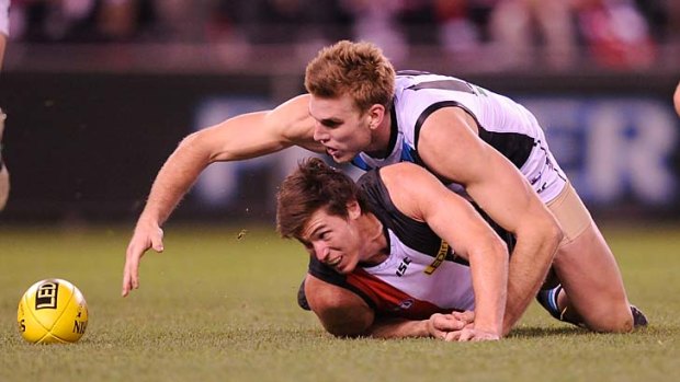 Close tangle: St Kilda's Lenny Hayes and Port's Jackson Trengove fight for the ball.