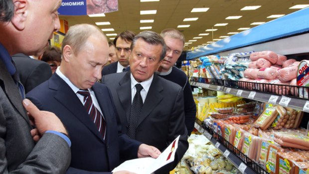 "Is that normal?'' ... Vladimir Putin  checks the prices at the  Perekrestok supermarket's sausage display.