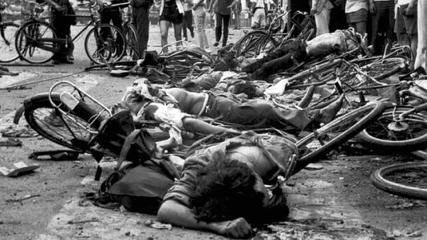 The bodies of dead civilians lie among mangled bicycles.