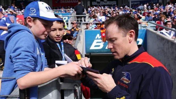 Brenton Sanderson signs an autograph for a young fan during the round 22 match against the Kangaroos on August 23.