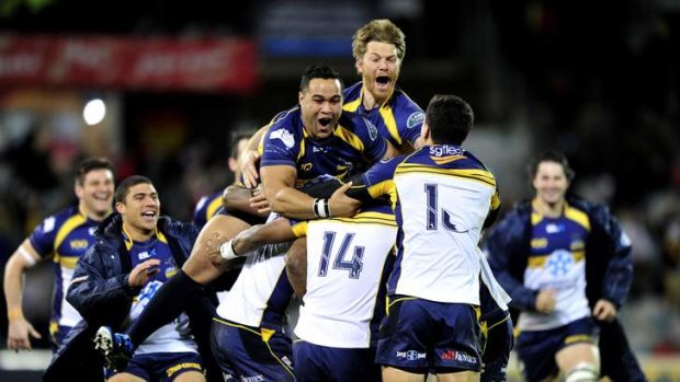 Brumbies players celebrate a famous win.