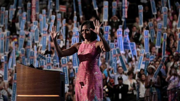 First lady in front: Michelle Obama waves to supporters after delivering her speech at the Democratic National Convention.