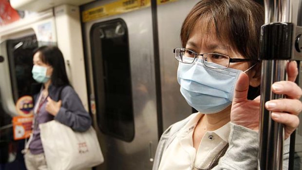 Cautious: People wear medical masks while commuting on a subway Taipei, Taiwan.