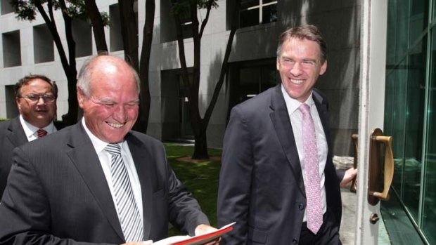 All smiles &#8230; independents Tony Windsor and Rob Oakeshott looked pleased with their dealings with Julia Gillard on the mining tax yesterday.