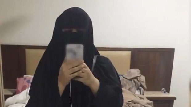 Two young Saudi sisters in Hong Kong say they were apprehended by kingdom officials.  One of the women takes a photo in a hotel room in Hong Kong. 