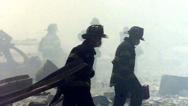 Scarred ... firefighters walk amid rubble near the World Trade Centre site on September 11, 2001.
