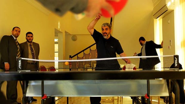 Smash ... a competitive Khalid Mishal plays table tennis with his security staff after his gym routine in Doha.