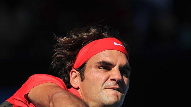 Hot shot: Roger Federer fires down a serve yesterday.
