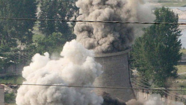 The cooling tower of North Korea's Yongbyon nuclear complex is demolished in 2008.