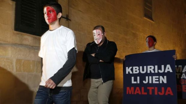 Members of Malta's opposition Nationalist Party's youth section protest against a controversial parliamentary bill to amend the Citizenship Act.