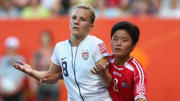 Amy Rodriguez of USA and Su Gyong Kim of Korea DPR during their Group C match.