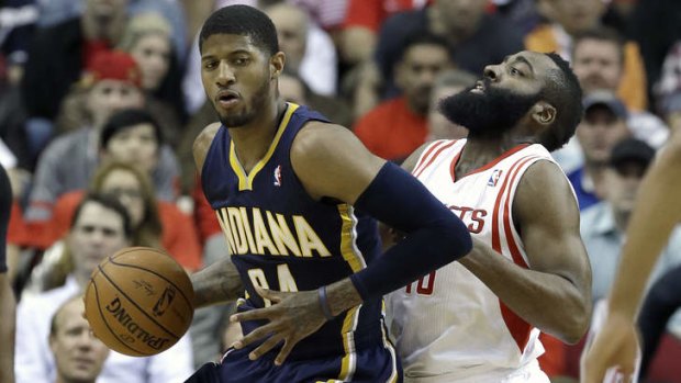 Indiana Pacers forward Paul George pushes against Houston Rockets guard James Harden.