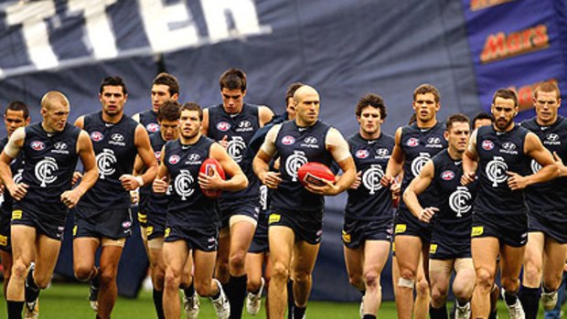 The Blues are lead out by captain Chris Judd before the start of their round 11 clash with Melbourne.
