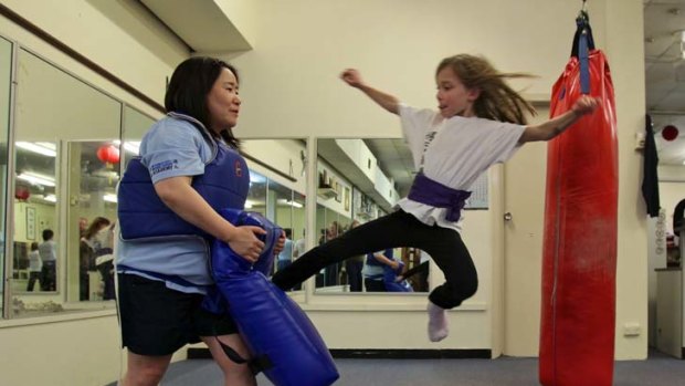 High kicks ... Sophie Anderson, 7,  shows her style to Michiko Umebayashi, during Little Dragon classes in the CBD.