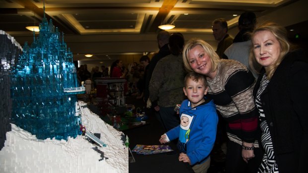 Michael Broomham, 6, with his mother Teresa Broomham and grandmother Pam Lichtenberg, all of Wollongong, next to the Lego Frozen castle. 