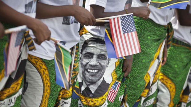 Next stop: Women wearing skirts with the face of President Barack Obama rehearse before welcoming him for his planned meeting with Tanzanian President Jakaya Kikwete.