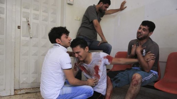Relatives of a man reportedly killed by an Israeli air strike grieve at Gaza's Shifa Hospital.