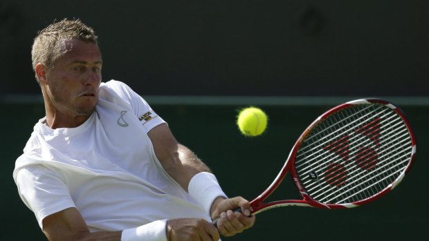 Fighting to the end ... Lleyton Hewitt returns a ball to Jarkko Nieminen of Finland during the men's singles first-round match at Wimbledon, London.