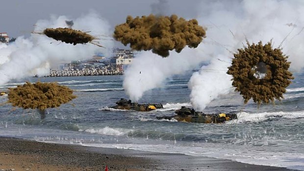 Amphibious assault vehicles of the South Korean Marine Corps throw smoke bombs during a US-South Korea joint landing operation drill in Pohang on Monday.