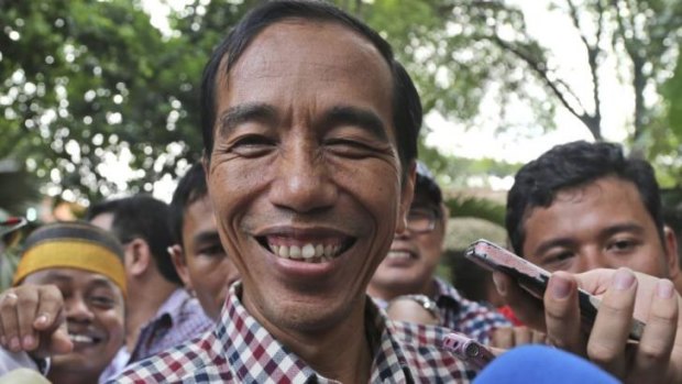 Joko Widodo, popularly known as "Jokowi", smiles as he is mobbed after a press conference in Jakarta on Wednesday.