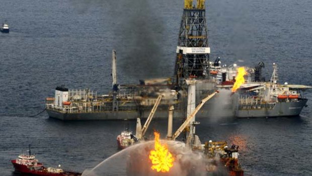 A rig burns oil and gas near the Discoverer Enterprise, background, at the site of the Deepwater Horizon oil spill in the Gulf of Mexico.