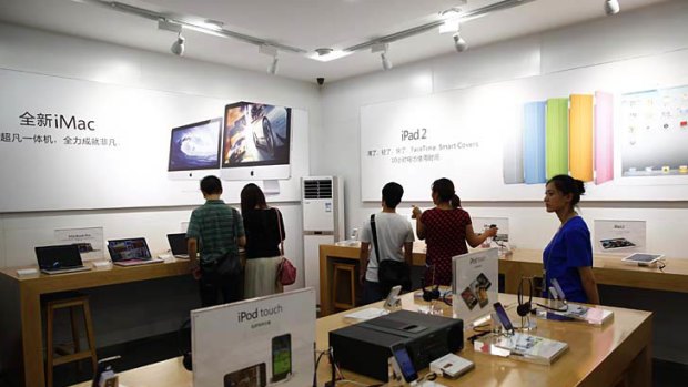 Customers and employees are seen inside a fake Apple Store in Kunming, Yunnan province on July 22, 2011.