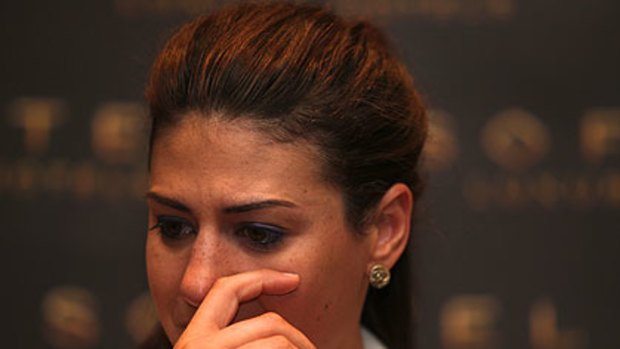 Stephanie Rice wipes a tear away at her press conference.