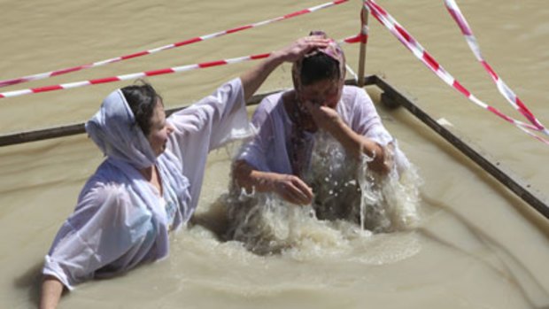 Orthodox Christian pilgrims at the section of the Jordan River where Jesus Christ is said to have been baptised.