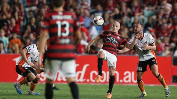 Aaron Mooy controls the ball for the home side.