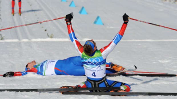 Russia's Nikita Kriukov reacts after crossing the finish line, ahead of compatriot Alexander Panzhinskiy.