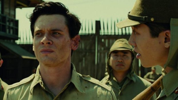 Working class hero: Jack O'Connell stars as American prisoner of war Louis Zamperini in the film <i>Unbroken</i>.