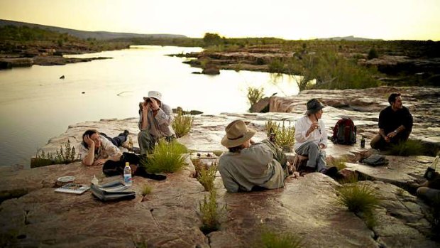Artists enjoy the sunset at Sir John Gorge, in the Australian Wildlife Conservancy in the Kimberley.