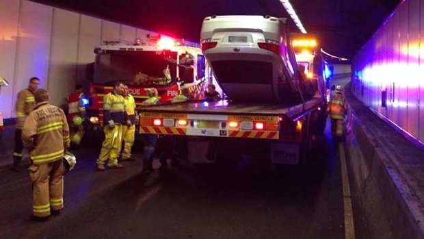 The car was put onto a truck to be removed after flipping in the Harbour Tunnel.